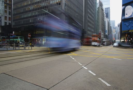 Tram crossing a road junction on Hong Kong Island in Hong Kong