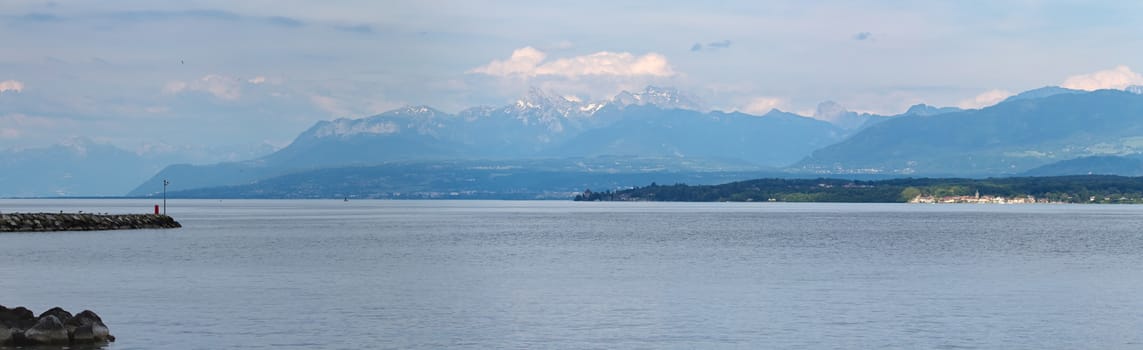 Geneva lake and Alps mountain by cloudy day, Switzerland