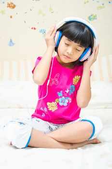 Girl listening the music by earphone, on white background.