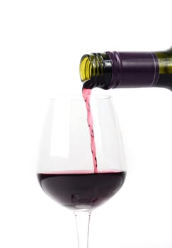 Red wine pouring into a glass on white background