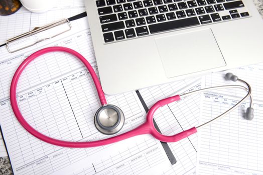 stethoscope and labtop and other medical object on the table