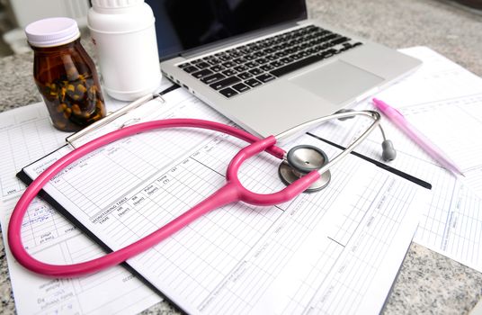stethoscope and labtop and other medical object on the table