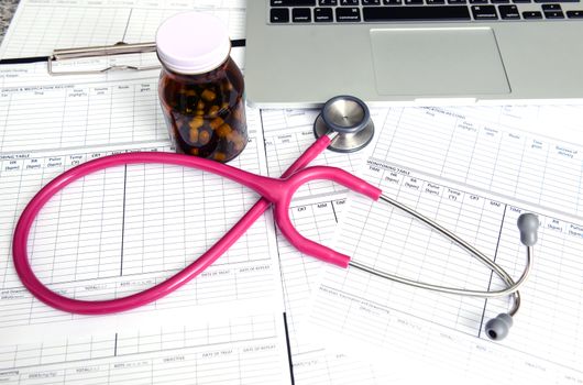 stethoscope and labtop and other medical object on the table