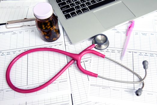 stethoscope and labtop and other medical object on the table