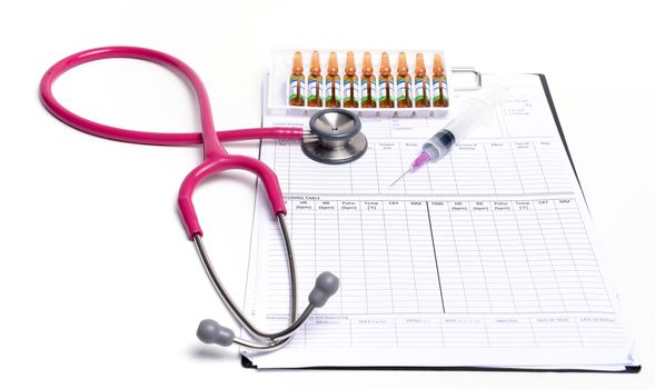 ampule syringe and stethoscope on white table