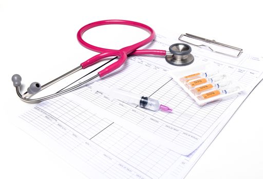 ampule syringe and stethoscope on white table