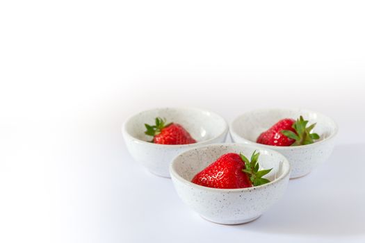 set of three ceramic bowls with strawberries