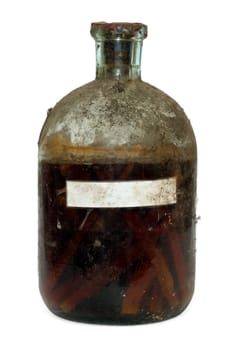 Vintage sealed bottle of aged spirit with chipped oak wood inside with a copy space isolated on white