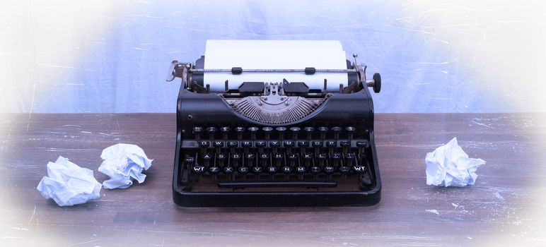 Vintage typewriter on wooden table, touch-up in retro style