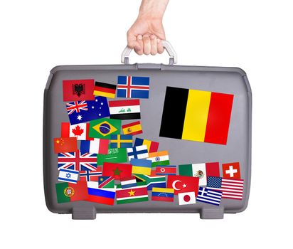 Used plastic suitcase with lots of small stickers, large sticker of Belgium