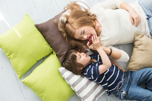 Cute, adorable boy with mother on the floor