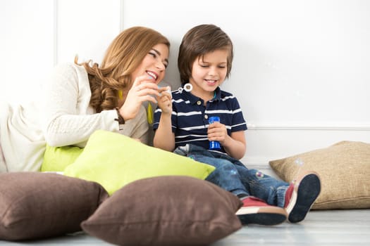 Cute, adorable boy with mother on the floor