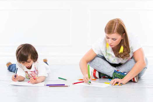 Cute, adorable boy with mother on the floor