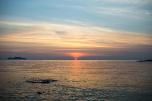 The large blue sky and seascape.