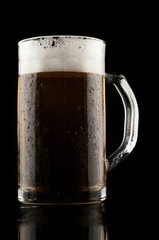 back lit glass mug with beer with reflection