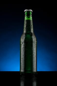 back lit green beer bottle with water drops