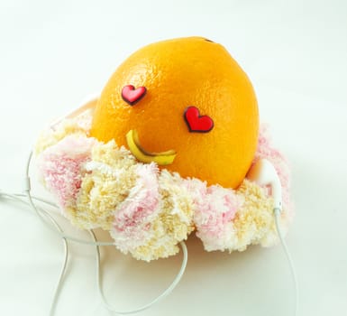 Orange yellow gold be decorated with the eyes and mouth, wearing headphones make sense of joy in life.                              