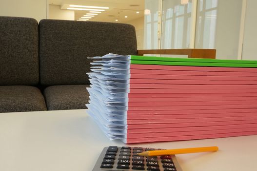 Pile of document and conference papers laid overlap on the desk in office.  