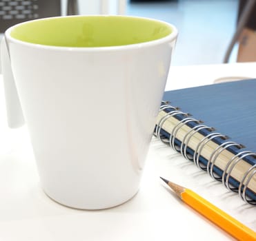 Notebook and pencil on the table keep before to restart after coffee break at work                             