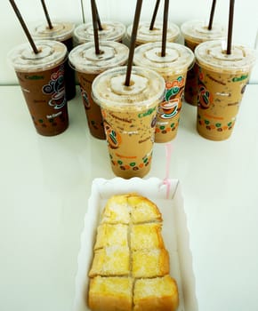 Iced coffee with toast bread, butter, sugar. It was snacks for meetings.                           