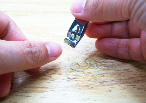 Cutting nails on the fingers of both hands. Using a nail clipper is stainless steel.                              