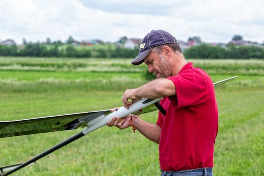 Man makes the assembly RC glider, closeup