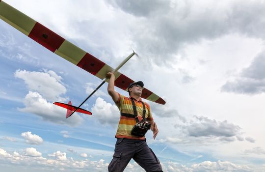 Man launches into the sky RC glider, wide-angle