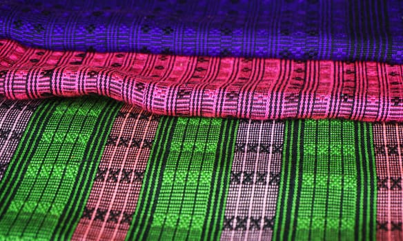 Patterned fabrics from Laos, as silk carpets are woven into the piece.                             