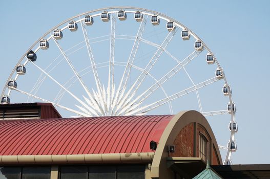 Large ferris wheel, the cabin air several cabinet. Hanging in the wheels of the system.                              