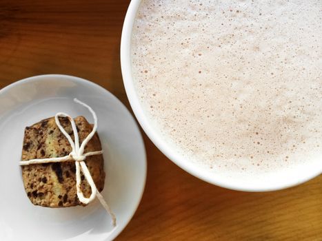 Cup of hot chocolate with whipped cream, and cookie.
