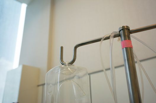The empty bottle of saline Hanging in the patient rooms.                              