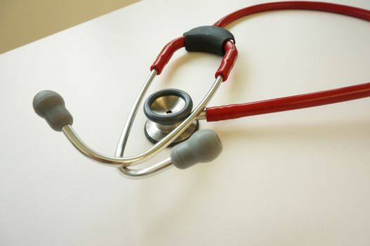 Medical stethoscope placed on the table in the examination room.                           