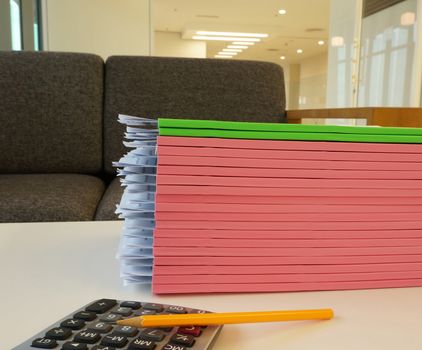 Multiple documents and receipt bill lay stacked on the desk.  
                               