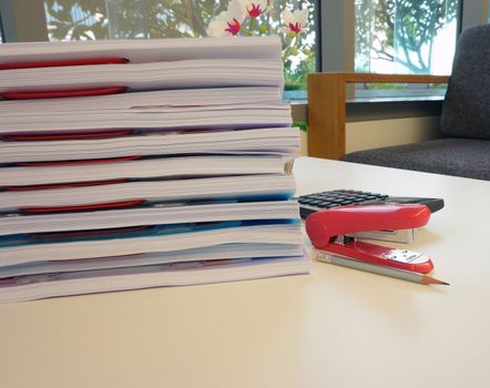 Office report and office equipment, such as calculators, pencil placed on the desk.                                  