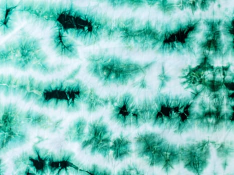 Light and dark green tie dyed fabric background