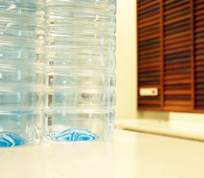 Bottles water purity, placed on white table in office.