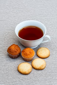 Cup cake, cookie and a cup of tea