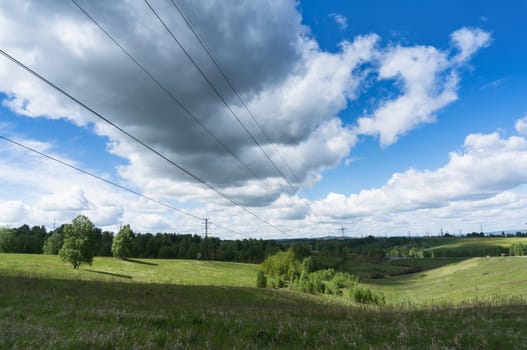 View of a power line with clouds floating over it