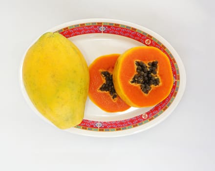 A ripe papaya had  yellow peel, The flesh of fruit is bright red, appetizing.                            