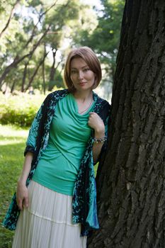 middle-aged woman walks in the Park in the summer of the tree