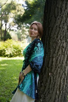 middle-aged woman walks in the Park in the summer of the tree