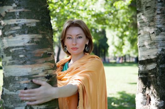 beautiful woman in birch summer in the Park for a walk