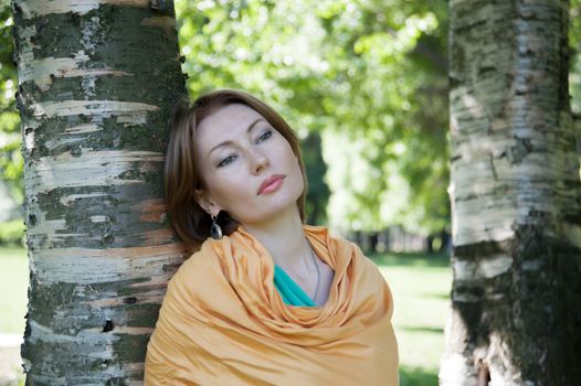 beautiful woman in birch summer in the Park for a walk