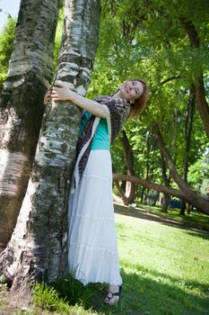 middle-aged woman walks in the Park in the summer of the tree