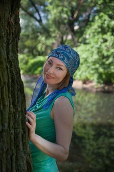 middle-aged woman walks in the Park in the summer of the tree