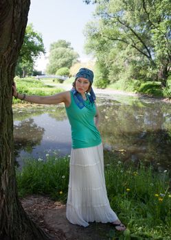 middle-aged woman walks in the Park in the summer of the tree