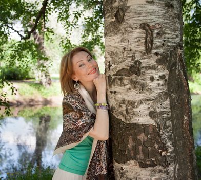 beautiful woman in birch summer in the Park for a walk