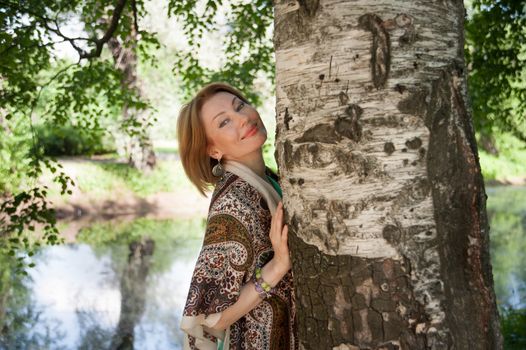 beautiful woman in birch summer in the Park for a walk