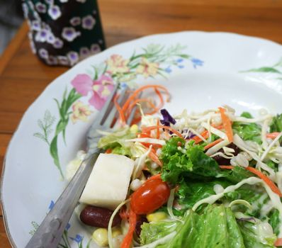 Salad topped with thick cream, mix well, put in a dish ready to eat.                               