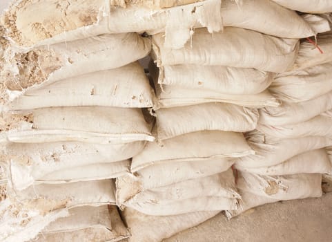 Old sandbags after the flood. Some disintegrating, the sand is outside the bag.